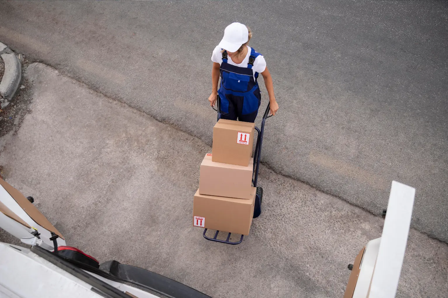 Warehouse worker moving boxed shipments as part of professional Logistics transportation services operations
