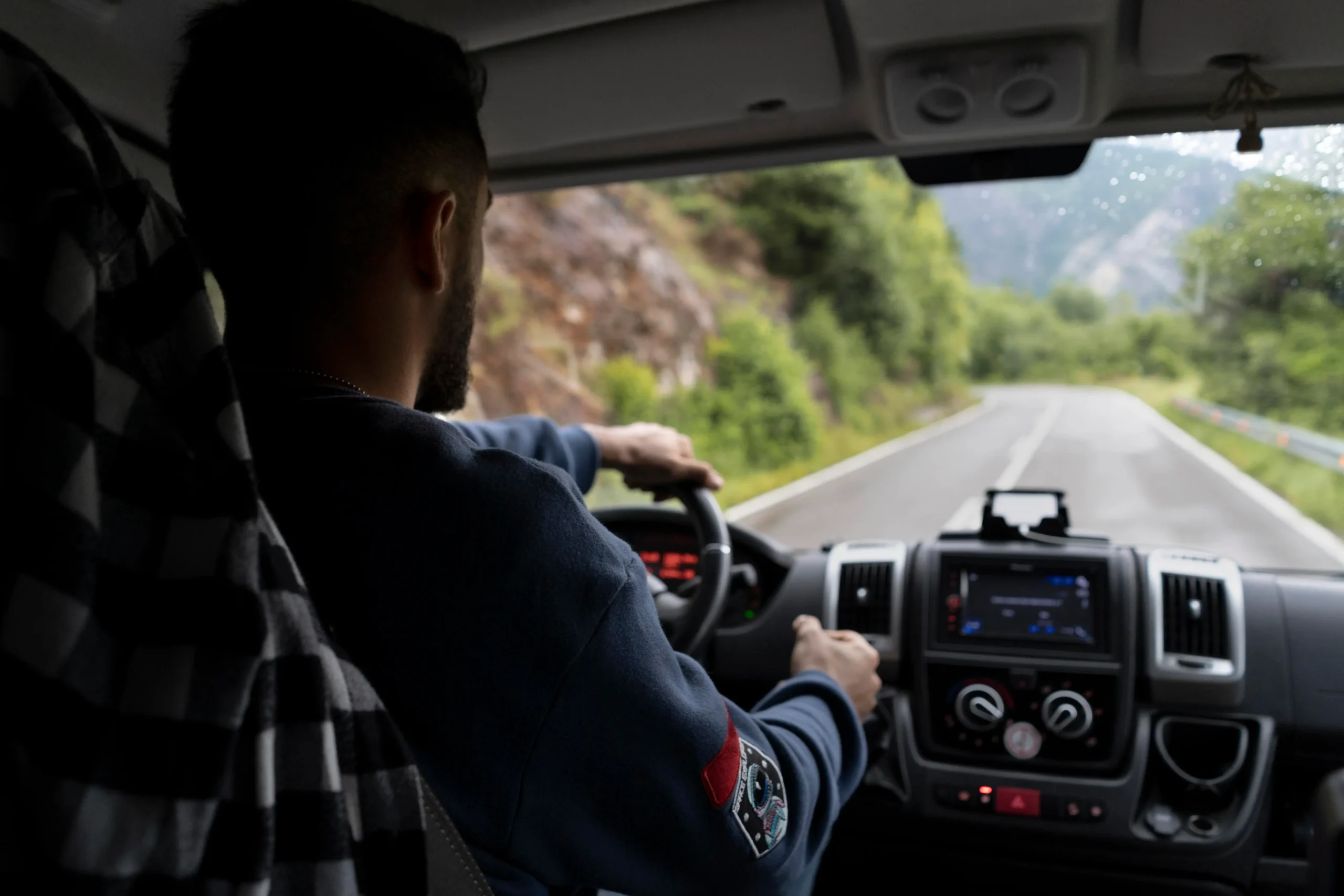 Professional driver resting inside vehicle during regional freight transport Canada route
