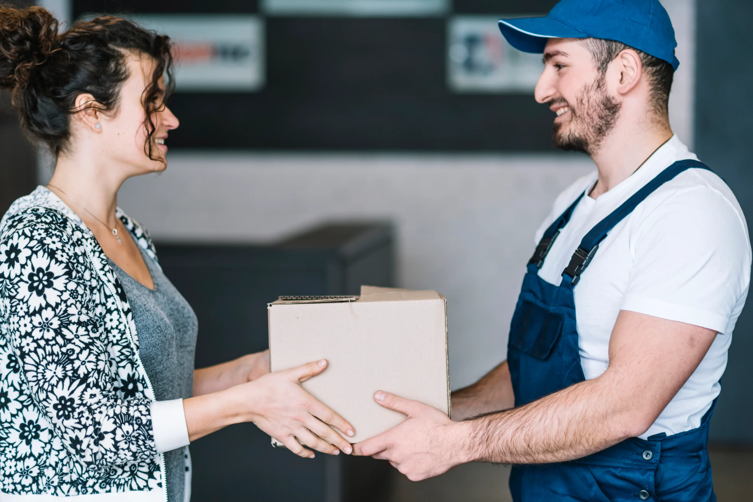 Courier handing parcel to customer in reliable freight delivery services