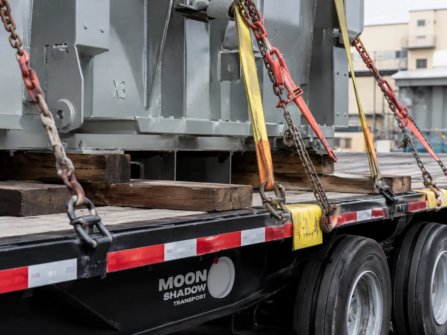 Heavy Haul Trucking BC & Canada securing oversized machinery with chains and tie-down systems for safe transport